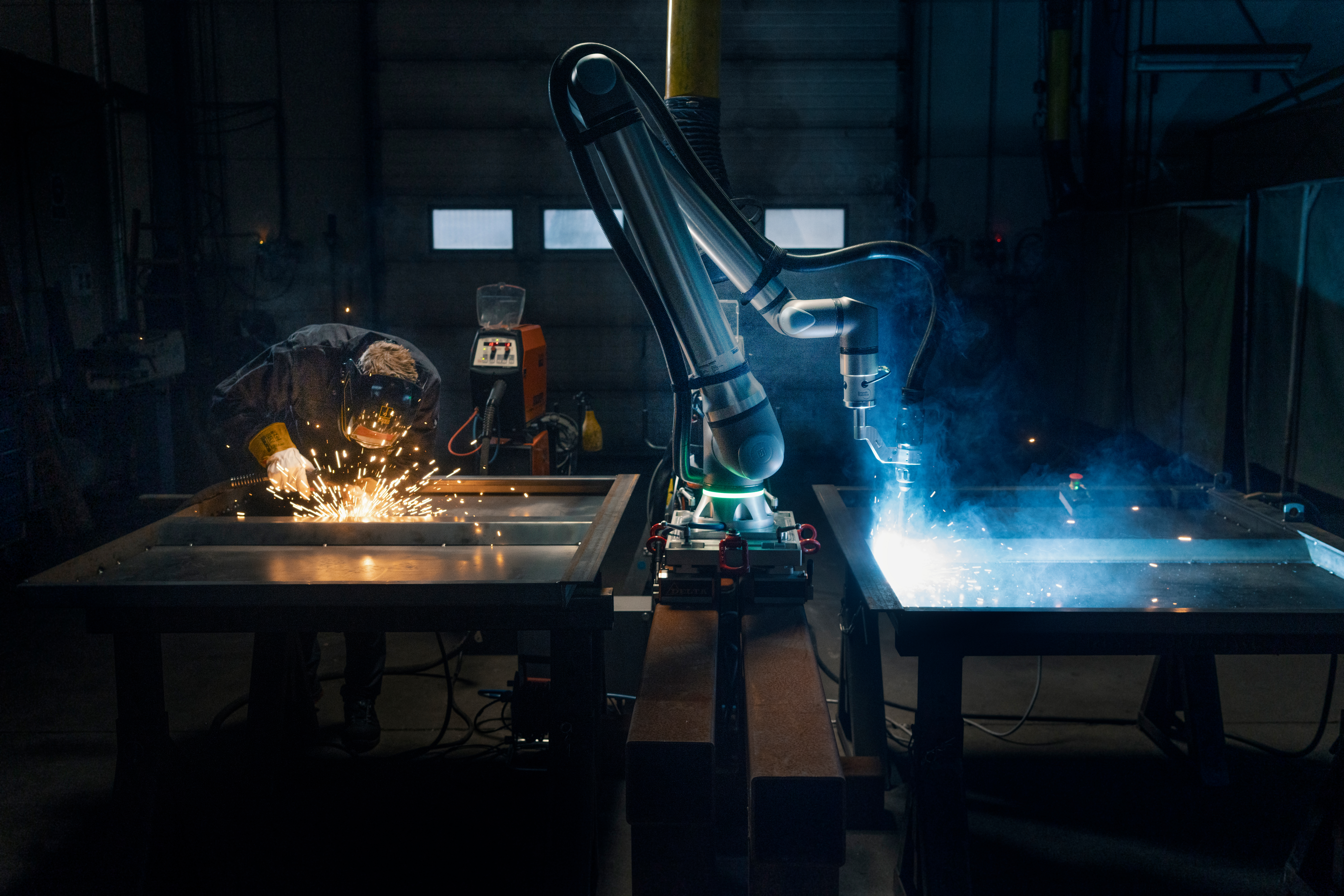 Universal Robots UR8 Long cobot welding a metal workpiece in an industrial cell